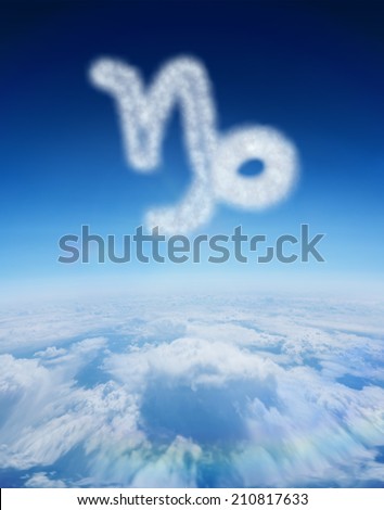 Cloud in shape of capricorn star sign against blue sky over clouds at high altitude