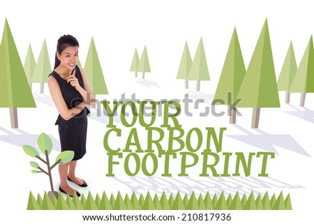 The word your carbon footprint and thoughtful businesswoman against forest with trees