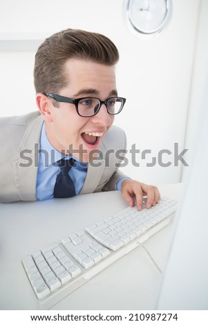 Excited businessman working on computer in his office