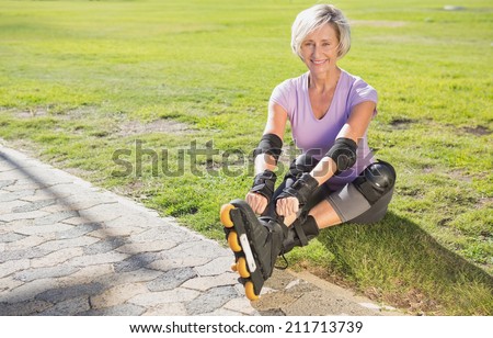 Active senior woman ready to go rollerblading on a sunny day