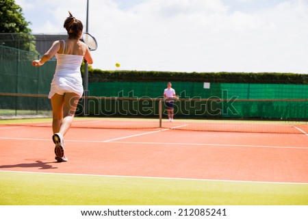 Tennis match in progress on the court on a sunny day
