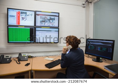 Technicians sitting in office running diagnostics in large data center