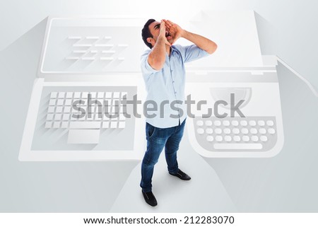 shouting casual man standing against laptop and typewriter