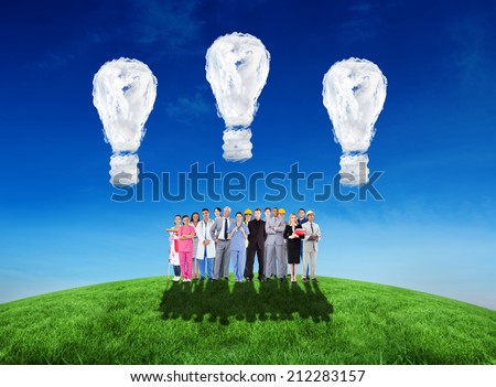 Smiling group of people with different jobs against cloud light bulbs