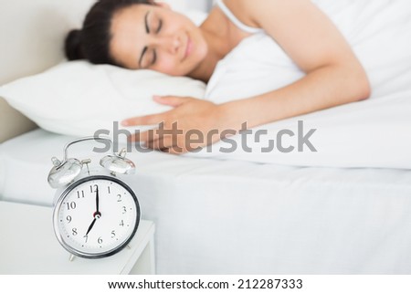 Relaxed beautiful young woman sleeping in bed at home
