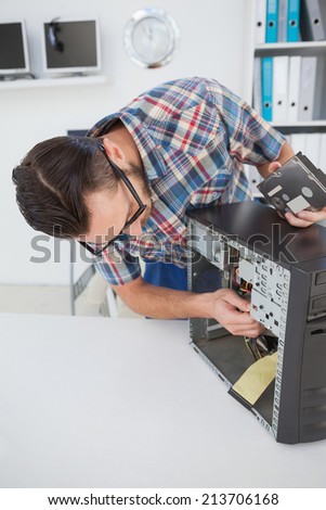 Computer engineer working on broken console in his office