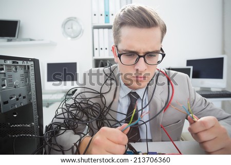 Computer engineer working on broken cables in his office