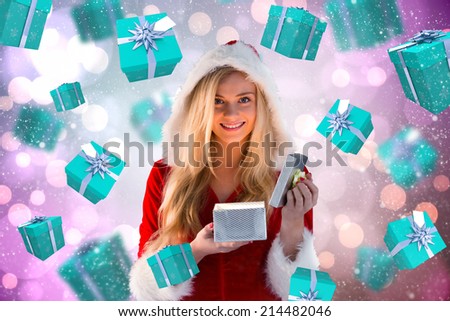 Sexy santa girl opening gift against light glowing dots on purple