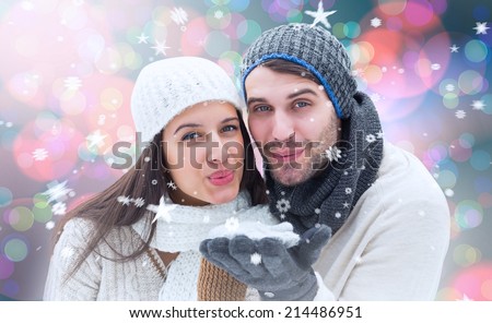 Young winter couple against light glowing dots on blue