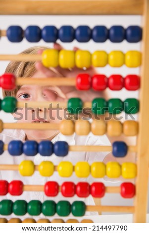 Student doing maths on abacus on white background