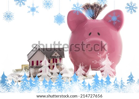 Snowflakes and fir trees against close up of a pink piggy bank with dollars beside miniature house model