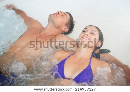 Close up of a relaxed young couple in swimming pool