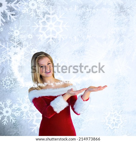 Pretty girl presenting in santa outfit against silver snow flake pattern design