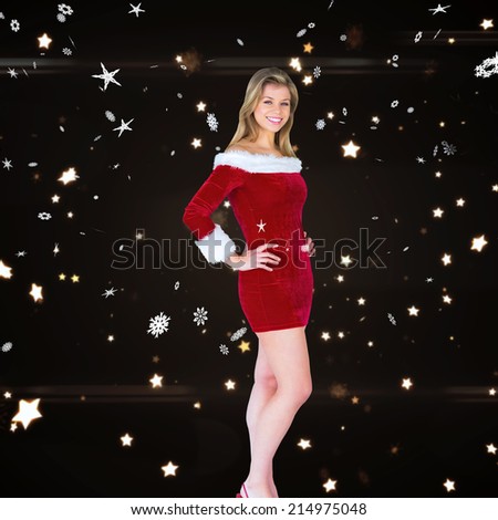 Pretty girl smiling in santa outfit against bright star pattern on black