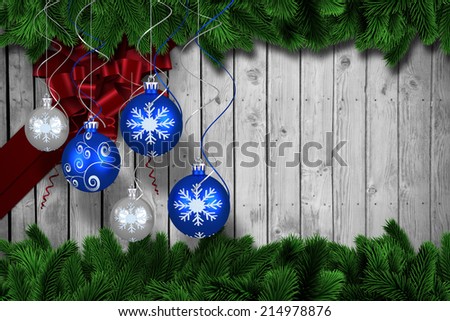 Digital hanging christmas bauble decoration against fir tree branches forming frame