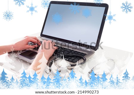 Businesswoman running computer diagnostics against snowflakes and fir trees