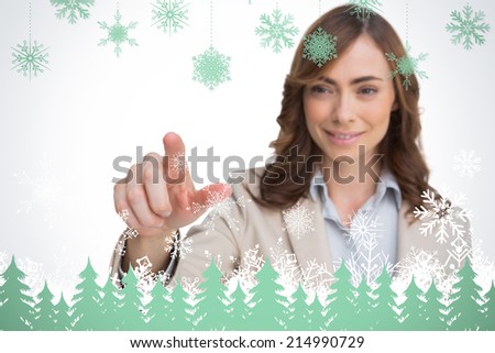 Portrait of businesswoman pointing her finger at camera against snowflakes and fir trees in green