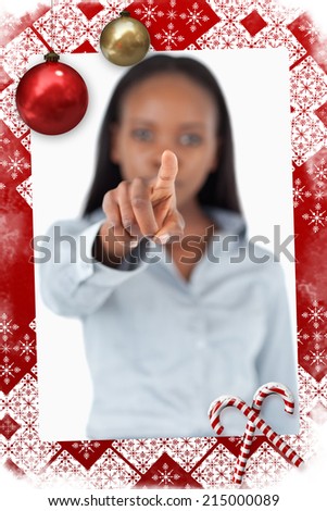 Portrait of a businesswoman touching an invisible screen against christmas themed page