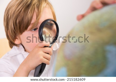 Student learning geography with globe on white background