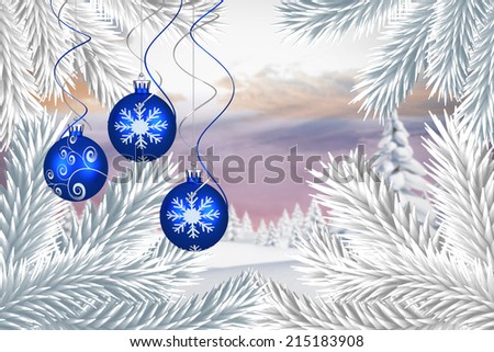 Digital hanging christmas bauble decoration against snowy landscape with fir trees