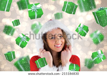 Sexy santa girl smiling at camera against light glowing dots design pattern