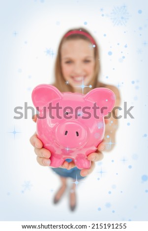 Fisheye view of a young woman tending a piggybank against snow falling
