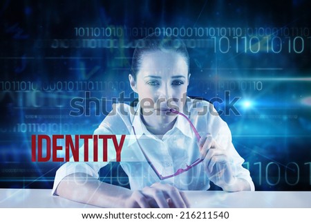 The word identity and businesswoman typing on a keyboard against blue technology design with binary code