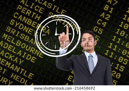 Serious asian businessman pointing to a white clock against black airport departures board for australia
