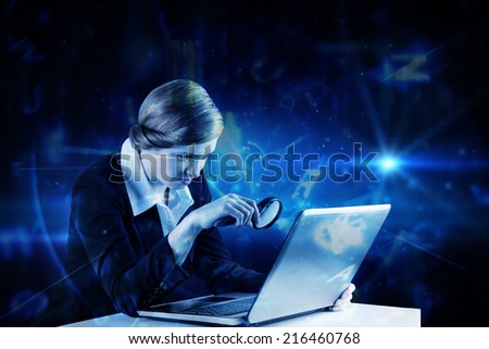 Redhead businesswoman using her laptop against blue background with letters