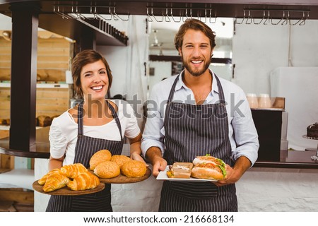 Happy servers holding plates of food at the coffee shop