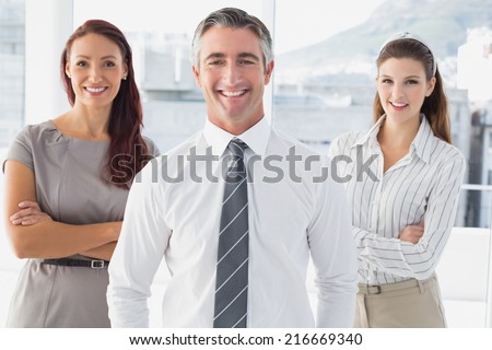Smiling businessman with his co-workers in an office