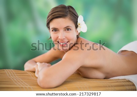 Side view of a beautiful young woman on massage table at health farm