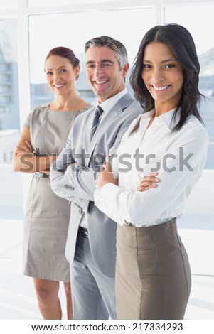 Businesswoman smiling while at work with co-workers