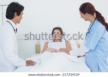 Doctor looking after his patient with a nurse