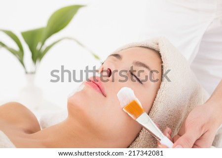 Close-up of an attractive young woman receiving treatment at spa center