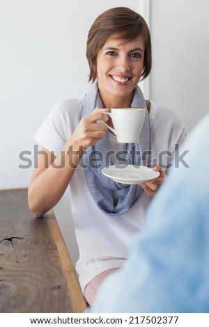 Casual woman having a coffee with friend at the coffee shop