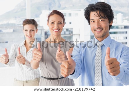 Business team standing all together with thumbs up