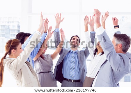 Business team raising their hands upwards