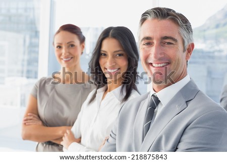 Businessman smiling while at work with co-workers