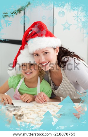 Beautiful mother and daughter cooking Christmas biscuits with christmas frame