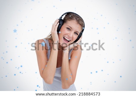 Woman singing while listening to music against snow falling