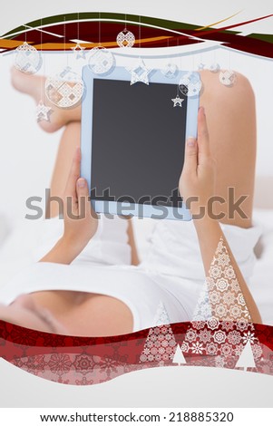 Calm woman touching her tablet pc against christmas frame