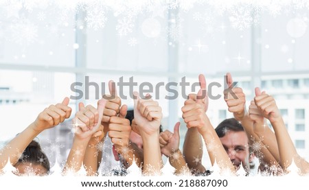 Composite image of a Closeup of cropped people gesturing thumbs up against snow falling