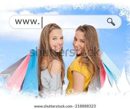 Smiling girls with their shopping bags under address bar against frost frame