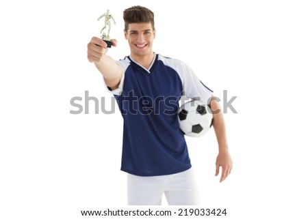 Football player holding winners trophy over white background
