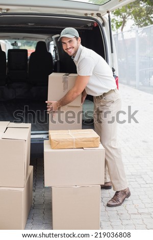 Delivery driver loading his van with boxes outside the warehouse
