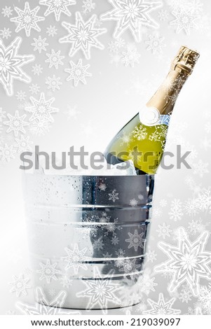 Composite image of snowflakes on silver against bottle of champagne chilling in ice bucket