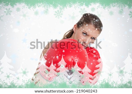 Composite image of ports woman boxing against green snowflake design