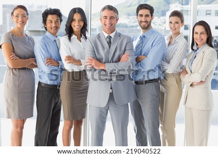 Happy workers standing all together in the workplace