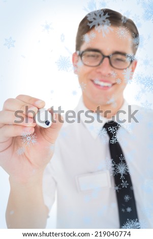 Nerdy businessman writing with black marker against snow falling